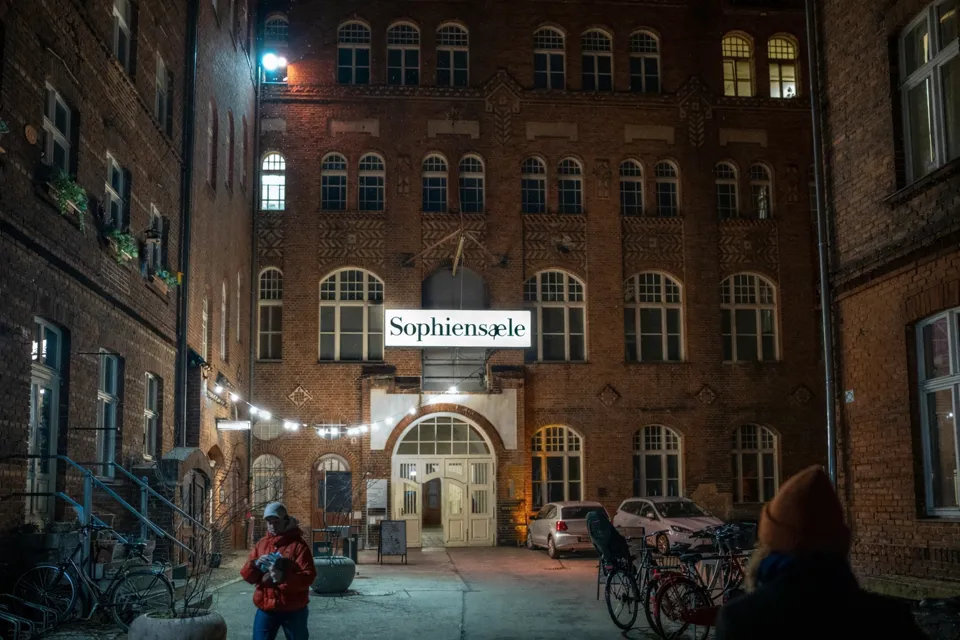 Der Innenhof der Sophiensæle am Abend, über dem Eingang leuchtet der Schriftzug Sophiensæle